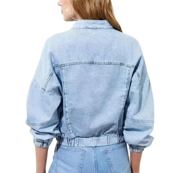 Light blue cropped denim jacket with zip front and patch pockets