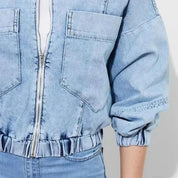 Light blue cropped denim jacket with zip front and patch pockets